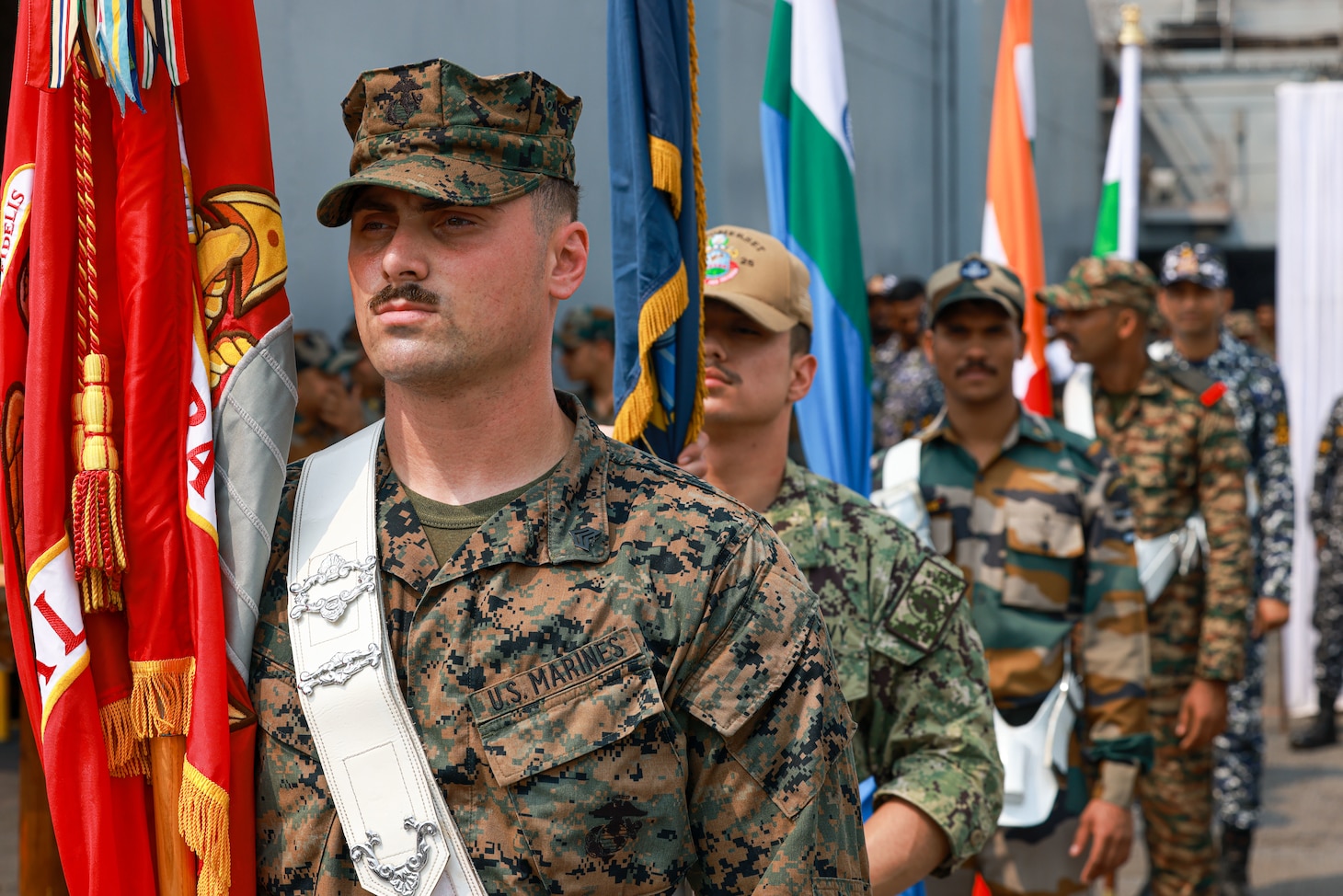 U.S. Marine Corps Sgt. Tristan Lake, a maintenance chief assigned to Combat Logistics Battalion 15, 15th Marine Expeditionary Unit, and a Michigan native, prepares to march with U.S. and Republic of India flag bearers for the opening ceremony of Exercise Tiger TRIUMPH in Visakhapatnam, India, March 19, 2024. Tiger TRIUMPH is a U.S.-India tri-service amphibious exercise focused on humanitarian assistance and disaster relief readiness and interoperability. Tiger TRIUMPH enables U.S. and Indian Armed Forces to improve interoperability and bilateral, joint, and service readiness in the Indian Ocean region and beyond to better achieve mutual regional security objectives. (U.S. Marine Corps photo by Cpl. Aidan Hekker)
