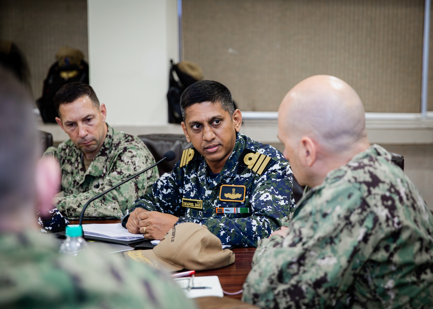 U.S. Navy Rear Adm. Joaquin Martinez, commander of the U.S. Joint Force for Tiger TRIUMPH, and Indian Navy representatives speak at a commander’s update brief in Visakhapatnam, India, March 20 during Exercise Tiger TRIUMPH 2024. Tiger TRIUMPH is a U.S.-India tri-service amphibious exercise focused on humanitarian assistance and disaster relief readiness and interoperability. Tiger TRIUMPH enables U.S. and Indian Armed Forces to improve interoperability and bilateral, joint, and service readiness in the Indian Ocean region and beyond to better achieve mutual regional security objectives. (Oklahoma National Guard photo by Cpl. Danielle Rayon)