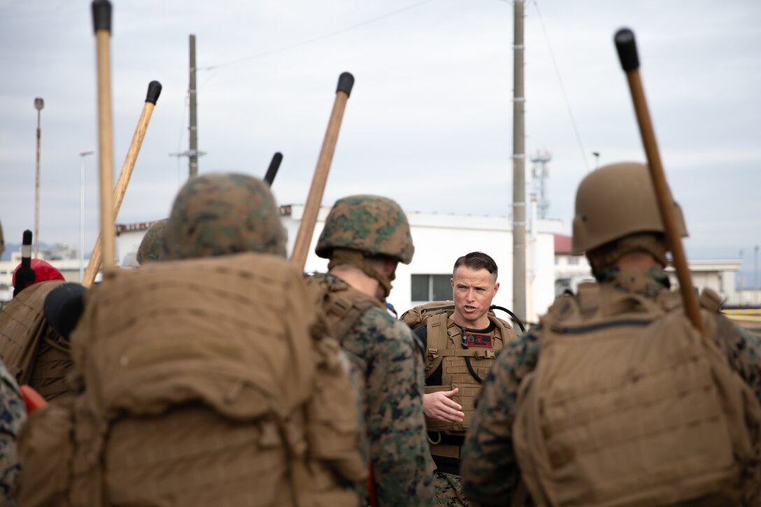 U.S. Marine Corps Gunnery Sgt. Mikael Marcy, a brig supervisor with Headquarters and Headquarters Squadron, Marine Corps Air Station Iwakuni, instructs a group of Marines during the culminating event of a Marine Corps martial arts instructor course at MCAS Iwakuni, Japan, Dec. 14, 2023. Graduates of the 15-day course become qualified Martial Arts Instructors, empowered to independently lead and facilitate courses, assisting lower-belt Marines in their progression towards higher belts. (U.S. Marine Corps photo by Lance Cpl. Colin Thibault)