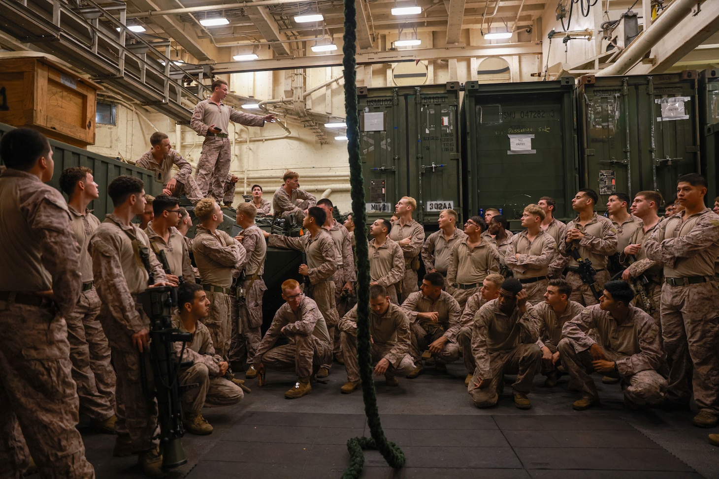 U.S. Marines assigned to Charlie Company, Battalion Landing Team 1/5, 15th Marine Expeditionary Unit, participate in a safety brief prior to fast-rope training aboard the amphibious transport dock USS Somerset (LPD 25) during Exercise Tiger TRIUMPH in Visakhapatnam, India, March 20, 2024. Tiger TRIUMPH is a U.S.-India tri-service amphibious exercise focused on humanitarian assistance and disaster relief readiness and interoperability. Tiger TRIUMPH enables U.S. and Indian Armed Forces to improve interoperability and bilateral, joint, and service readiness in the Indian Ocean region and beyond to better achieve mutual regional security objectives. (U.S. Marine Corps photo by Cpl. Aidan Hekker)