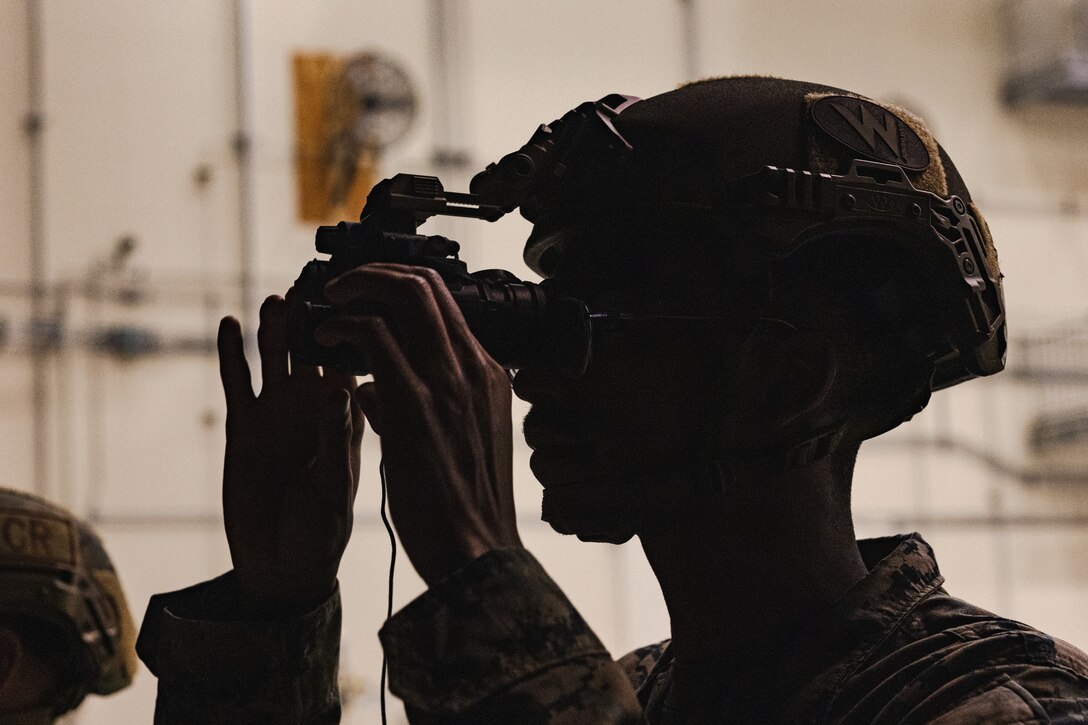 U.S. Marine Corps Cpl. Kalonje Gordon, a distribution management specialist with the Marine Corps Air Station Iwakuni Distribution Management Office, adjusts the settings on a pair of Gen III AN/AVS-9 night vision goggles during a training exercise at Marine Corps Air Station Iwakuni, Japan, Dec. 13, 2023.  The U.S. Air Force 36th Contingency Response Group conducted joint training that focused on equipment and process interoperability in a contested logistics environment with the MCAS Iwakuni Headquarters and Headquarters Squadron Logistics Department and members of the Japan Air Self-Defense Force.  (U.S. Marine Corps photo by Cpl. Darien Wright)
