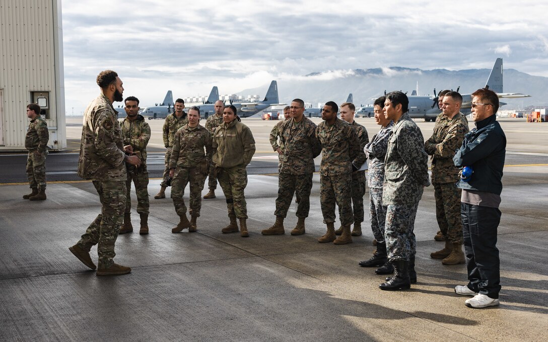 U.S. Air Force Staff Sgt. Juan Martinez, a fuels specialist with the U.S. Air Force 36th Contingency Response Squadron, 36th Contingency Response Group, gives a class on fuel distribution and transportation during a training exercise at Marine Corps Air Station Iwakuni, Japan, Dec. 12, 2023. The U.S. Air Force 36th Contingency Response Group conducted joint training that focused on equipment and process interoperability in a contested logistics environment with the MCAS Iwakuni Headquarters and Headquarters Squadron Logistics Department and members of the Japan Air Self-Defense Force.  (U.S. Marine Corps photo by Cpl. Darien Wright)