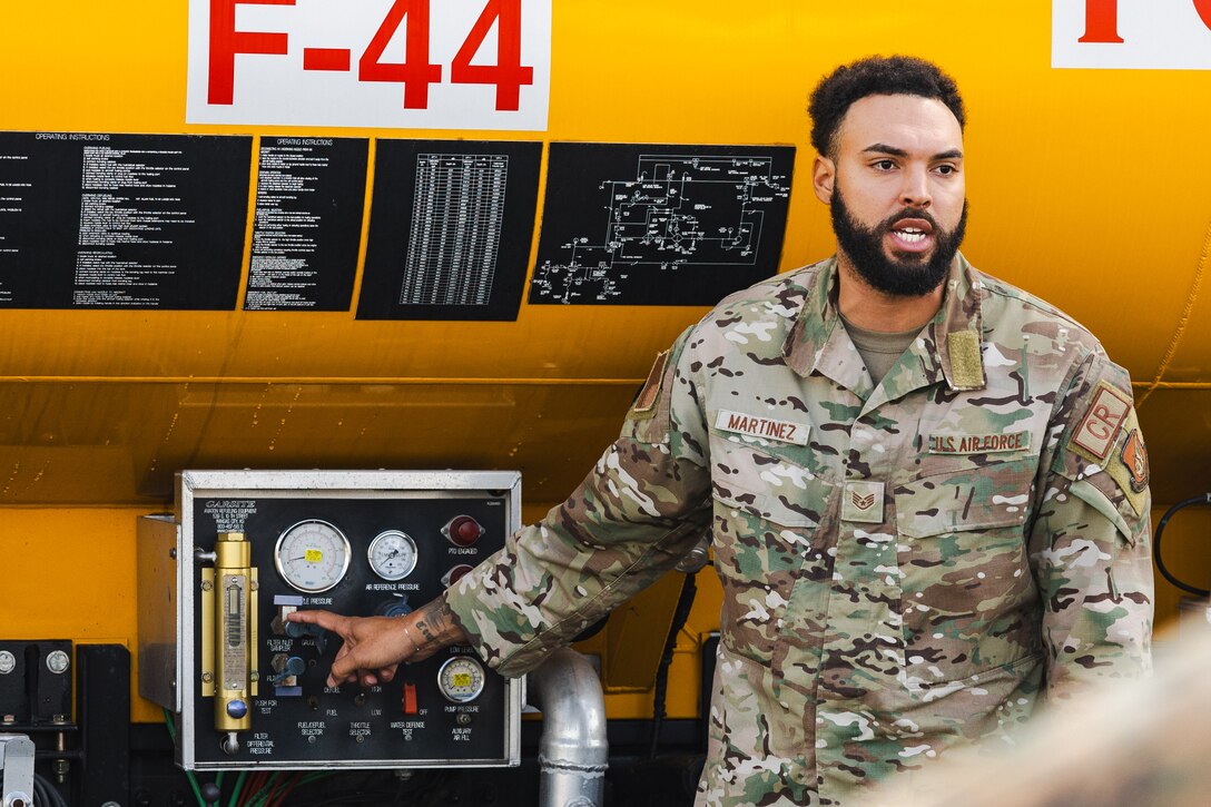 U.S. Air Force Staff Sgt. Juan Martinez, a fuels specialist with the U.S. Air Force 36th Contingency Response Squadron, 36th Contingency Response Group, explains the capabilities of a jet refueler during a training exercise at Marine Corps Air Station Iwakuni, Japan, Dec. 12, 2023. The U.S. Air Force 36th Contingency Response Group conducted joint training that focused on equipment and process interoperability in a contested logistics environment with the MCAS Iwakuni Headquarters and Headquarters Squadron Logistics Department and members of the Japan Air Self-Defense Force.  (U.S. Marine Corps photo by Cpl. Darien Wright)