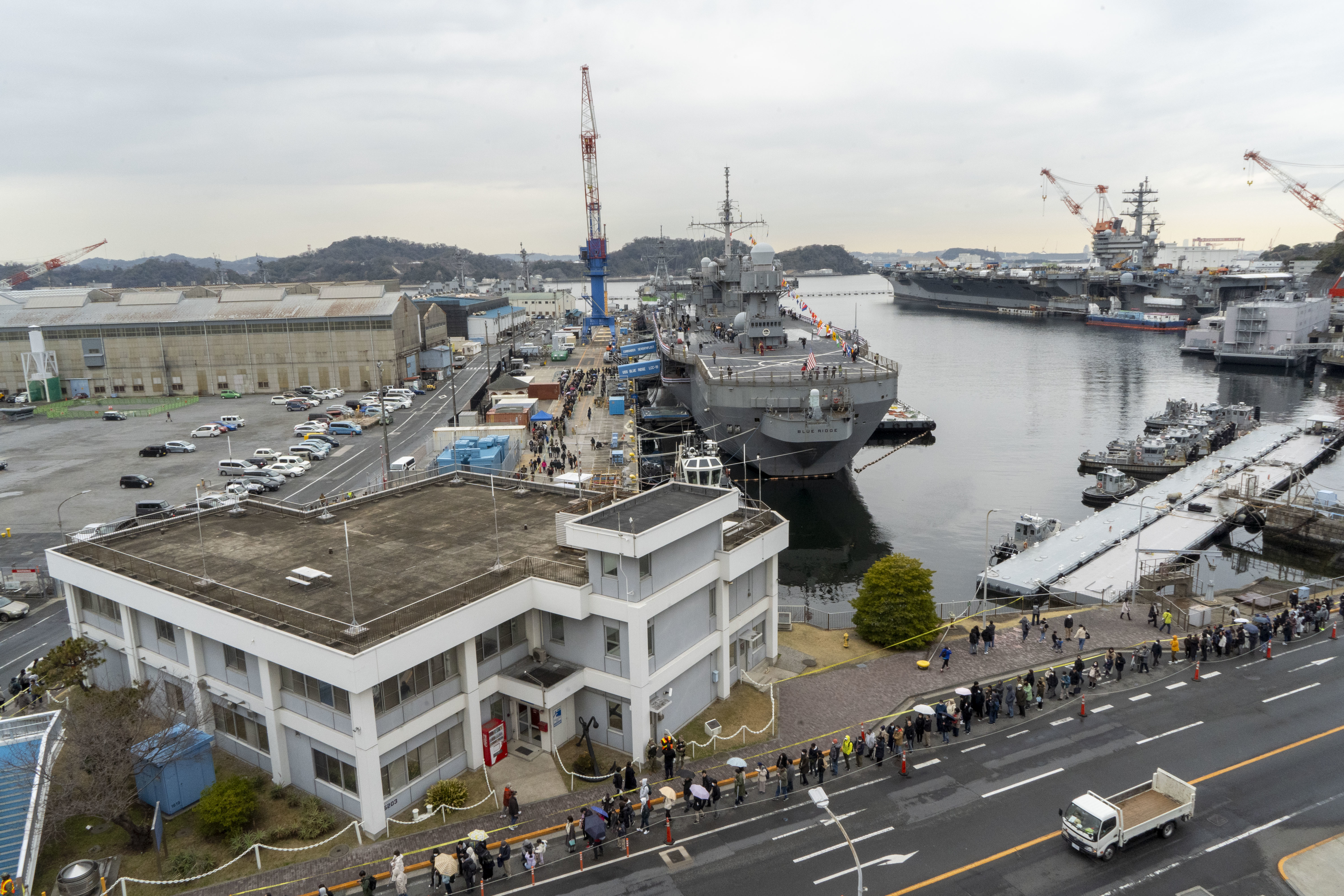 Japanese community members wait in line for a ship tour onboard Commander, Fleet Activities Yokosuka (CFAY) during the 2024 Commander, Fleet Activities Yokosuka (CFAY) Spring Festival event.
