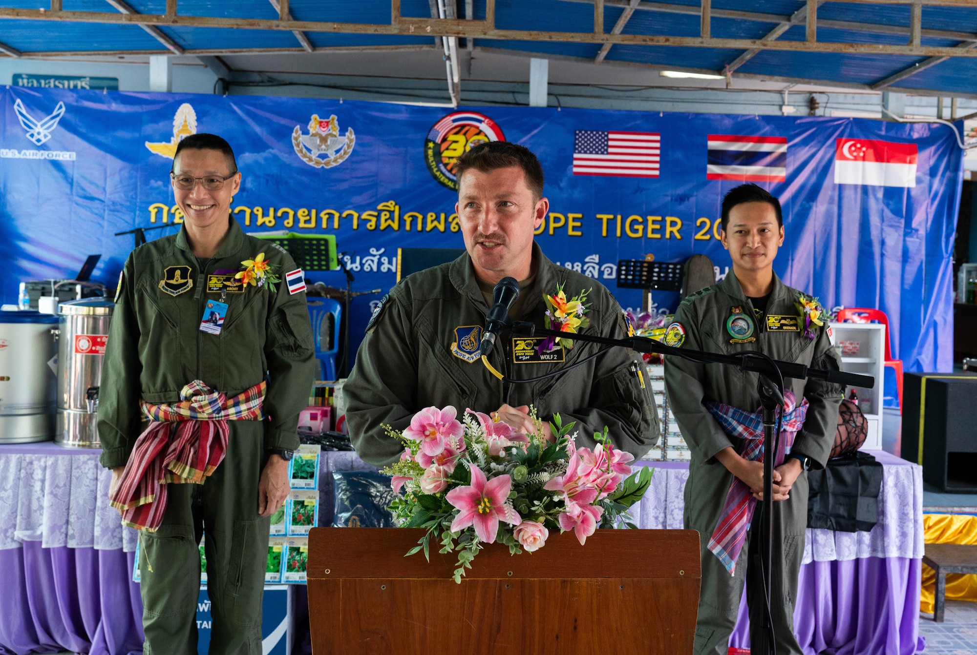U.S. Air Force Col. Jeffrey Shulman, Cope Tiger 2024 exercise director, gives remarks at a ceremony during a community outreach event for Cope Tiger 2024, Ban Krok Duan Ha School, Nakhon Ratchasima Province, Thailand, March 21, 2024. After the ceremony, Shulman joined the exercise directors from the Royal Thai Air Force and Republic of Singapore Air Force in a ribbon cutting ceremony for a new facility on the school campus, planted seeds in the garden, toured the school and served lunch to the students. (U.S. Air Force photo by Tech. Sgt. Hailey Haux)