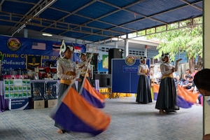 Students perform a classical dance during a ceremony during a community outreach event for Cope Tiger 2024, Ban Krok Duan Ha School, Nakhon Ratchasima Province, Thailand, March 21, 2024. As part of the outreach event, U.S. Air Force Airmen participated in various activities like local games such as relay races, ball tosses, and a competitive game of rock, paper, scissors. (U.S. Air Force photo by Tech. Sgt. Hailey Haux)