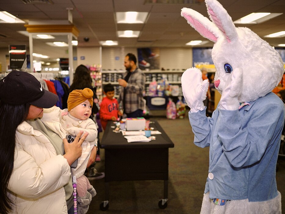 A baby is entertained by the Easter Bunny in the Navy Exchange Yokosuka Children's Store March 24, 2024 at Commander, Fleet Activities Yokosuka's Main Base.