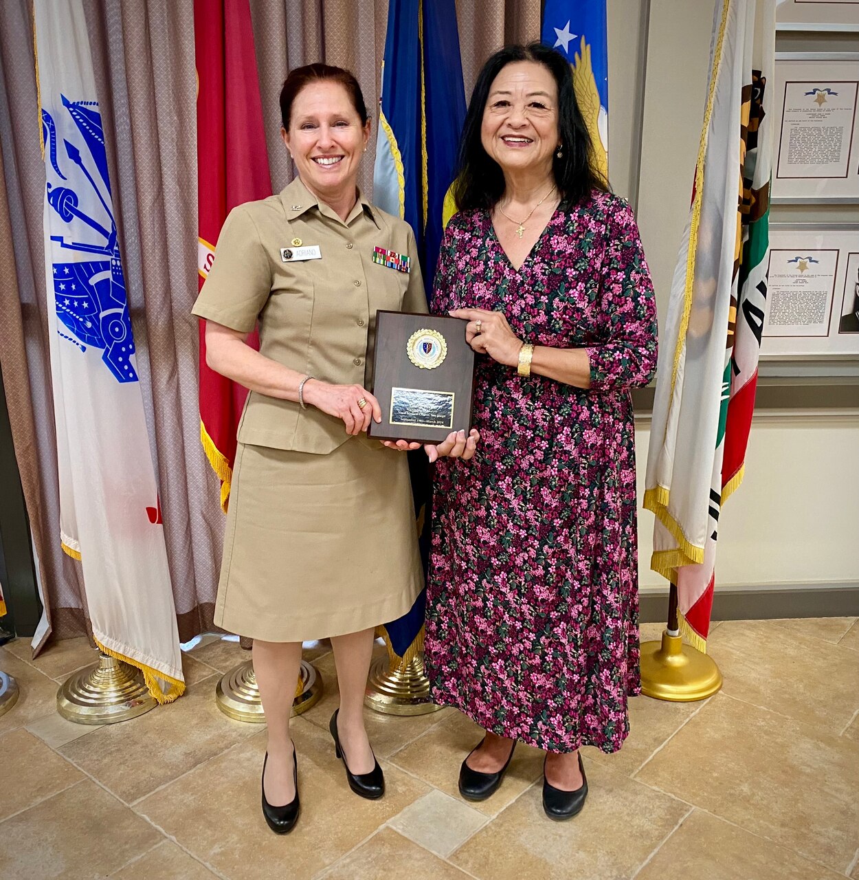 SAN DIEGO (March 22, 2024)  Capt. Elizabeth Adriano, left, Naval Medical Center San Diego (NMCSD) director, presents Valorie Braun, NMCSD Human Resources Department management analyst, with a 40 year Length of Service plaque, March 22, 2024.  Braun is schedule to retire in 2024.  The mission of NMCSD is to prepare service members to deploy in support of operational forces, deliver high quality health care services, and shape the future of military medicine through education, training, and research. NMCSD employs more than 5,000 active-duty military personnel, civilians and contractors in southern California to provide patients with world-class care.  Anchored in Excellence, Committed to Health!