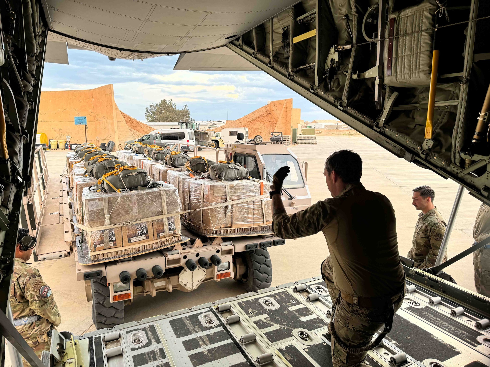 Loadmasters prepare to load Jordanian-aid destined for Gaza onto a HC-130J aircraft.