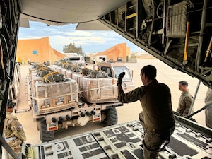 Loadmasters prepare to load Jordanian-aid destined for Gaza onto a HC-130J aircraft.