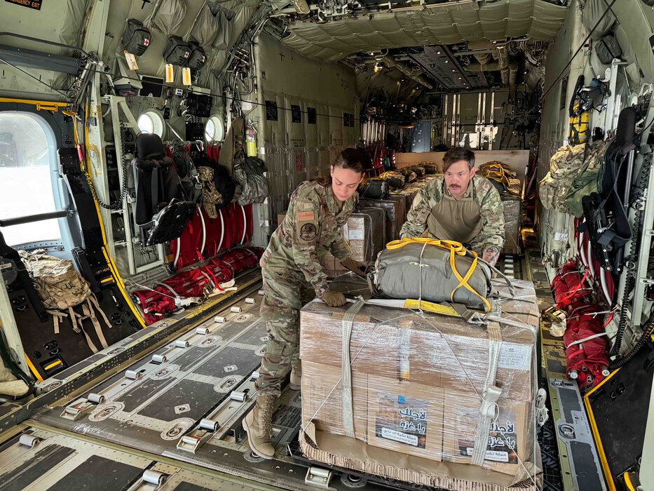 Service members load Jordanian-aid destined for Gaza onto a HC-130J aircraft.
