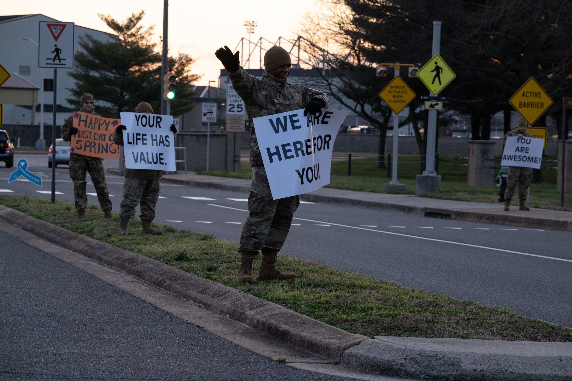 Members of Team Dover’s resilience team hold positive affirmation signs at the north gate on Dover Air Force Base, Delaware, March 19, 2024. Each team member held up different signs of encouraging messages as vehicles entered the base. (U.S. Air Force photo by Airman 1st Class Dieondiere Jefferies)