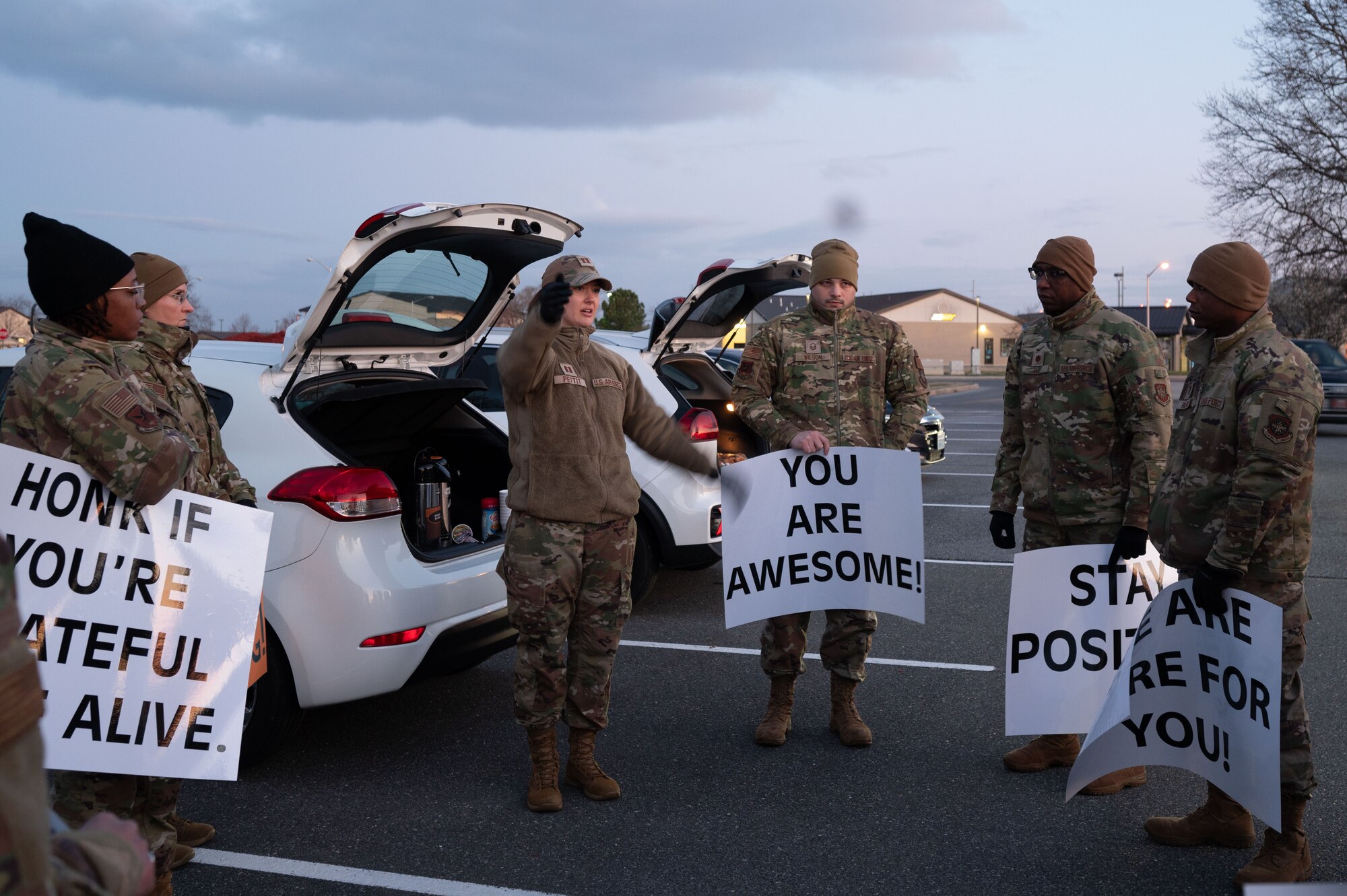 Members of Team Dover’s resilience team gather before holding positive affirmation signs at Dover Air Force Base, Delaware, March 19, 2024. Each team member held up differents sign displaying an encouraging message for personnel to read as they entered the base. (U.S. Air Force photo by Airman Liberty Matthews)