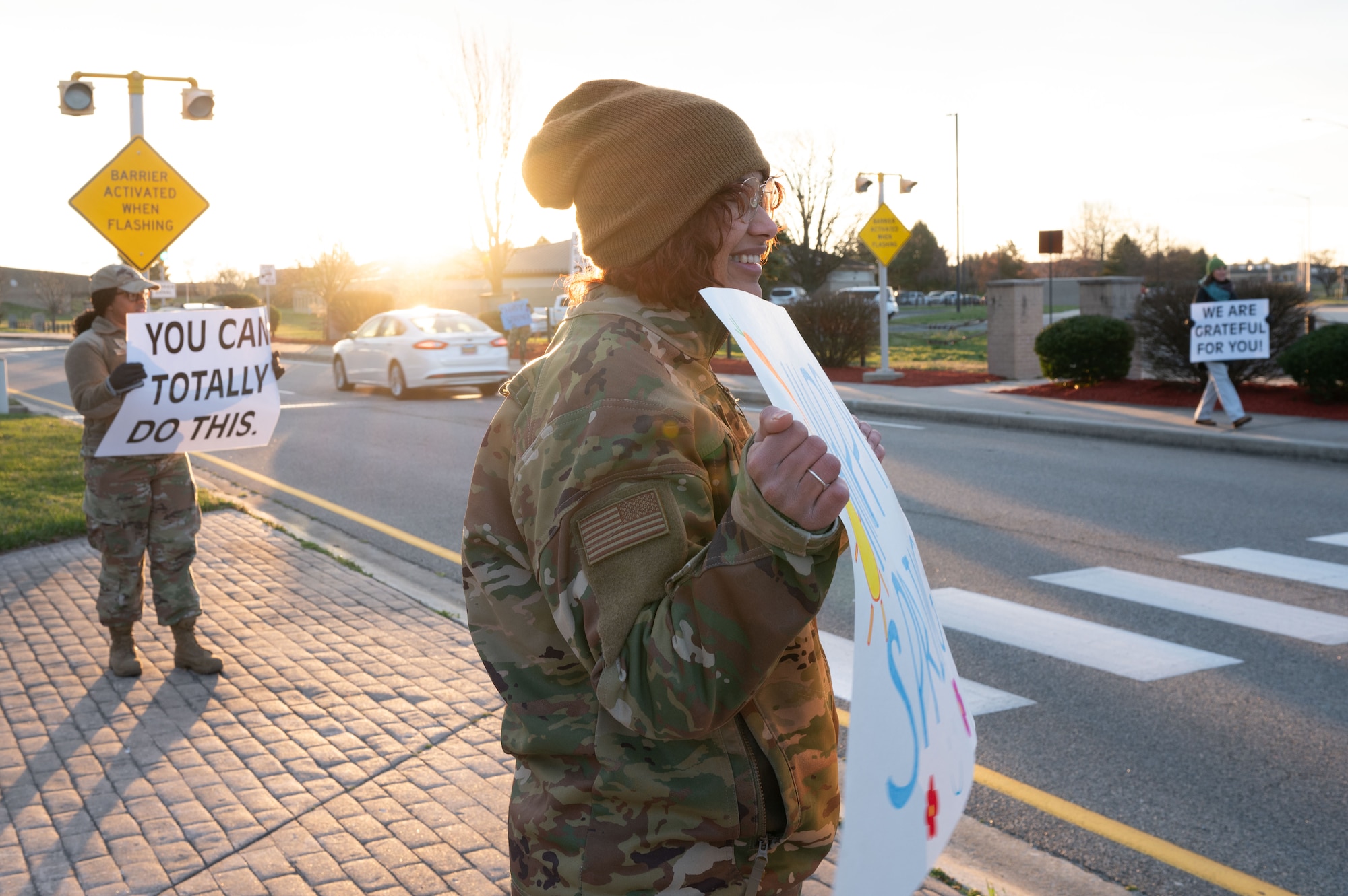 Members of Team Dover’s resilience team hold positive affirmation signs at the main gate on Dover Air Force Base, Delaware, March 19, 2024. Each team member held up a different sign displaying an encouraging message for personnel to read as they entered the base. (U.S. Air Force photo by Airman Liberty Matthews)