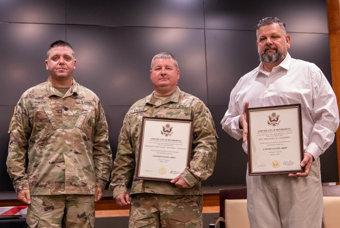 Sgt. 1st Class Richard Knowles, center, and Sgt. 1st Class Michael Caceres, right, both of Petersburg, are presented with certificates of retirement from Lt. Col. Wyatt Bickett, of Smithton, during a joint retirement ceremony March 23 at the Illinois Military Academy, Camp Lincoln, Springfield.