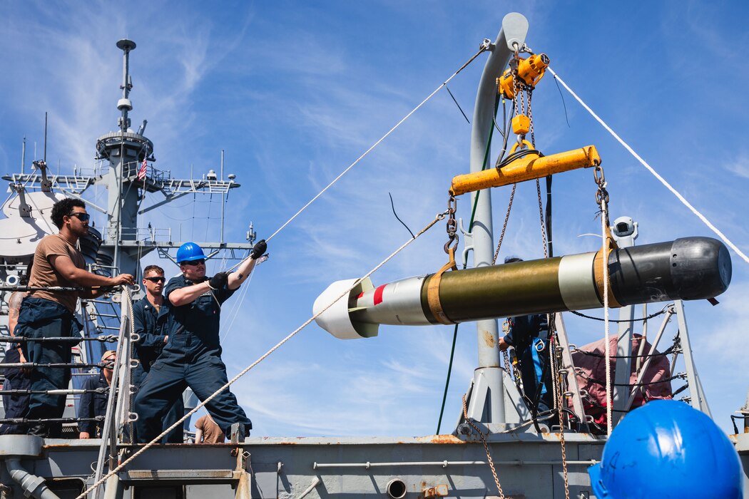 Sailors hoist a torpedo aboard USS John S. McCain (DDG 56).