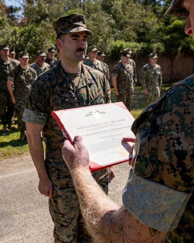 U.S. Marine Corps Gunnery Sgt. Benjamin Frazier, an intel instructor with Marine Corps Detachment Dam Neck, Virginia, receives the Navy and Marine Corps Commendation Medal for saving the life of a fellow Marine at Naval Air Station Dam Neck, Virginia, March 21, 2024. Since December 6, 1941, this medal has been awarded to Sailors and Marines that have distinguished themselves through heroic or meritorious service.