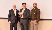 Lt. Gen. Sean A. Gainey, right, commanding general of U.S. Army Space and Missile Defense Command, and Bob Strider, left, Air, Space and Missile Defense Association president, present a Service Excellence Awards in the Government Individual Category to USASMDC team member Tommy Lum during the ASMDA annual membership luncheon, March 21, in Huntsville, Alabama. During the luncheon, Team Redstone members received 12 awards from ASMDA. (U.S. Army photo by Jason B. Cutshaw)