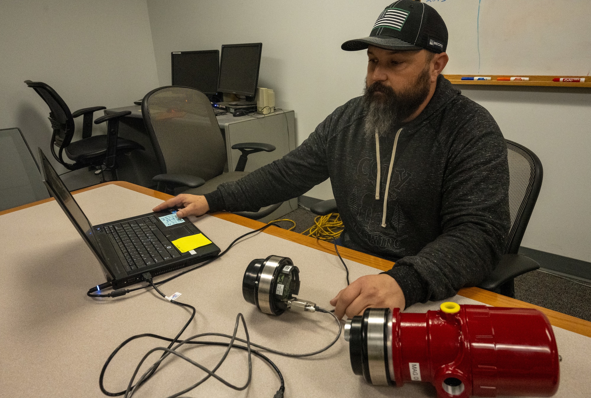 Clay Hudson, 509th Civil Engineer Squadron Fire Alarm and Suppression Team work lead reviews the team's test and calibration kit at Whiteman Air Force Base, Mo., March 1, 2024. FAST procured the kit to streamline their process to recalibrate their triple infrared flame detection systems. (U.S. Air Force photo by Airman 1st Class Hailey Farrell)