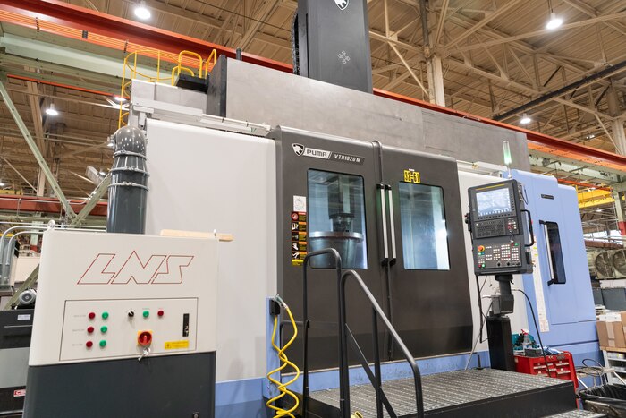 A wind tunnel nozzle is shaped inside the recently-acquired vertical turning center, or VTC, March 5, 2024, in the Arnold Air Force Base Model and Machine Shop at Arnold AFB, Tenn. The VTC operates similarly to a wood lathe except items are situated vertically on a rotating table within the machine chamber. As the piece rotates, carbide blades within the chamber are used to mill and grind until the piece is formed into the desired shape. The VTC was needed to accelerate the fabrication of various-sized nozzles to be installed in a wind tunnel at Arnold AFB, headquarters of Arnold Engineering Development Complex. (U.S. Air Force photo by Keith Thornburgh)