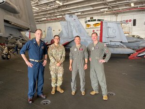 Men stand in front of plane