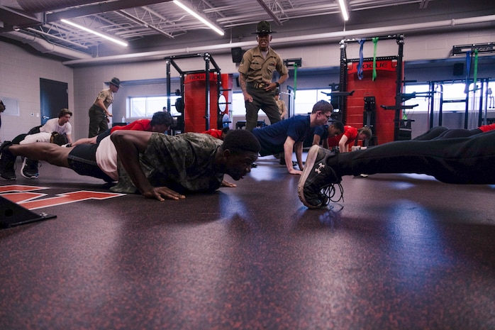 U.S. Marine Corps Sgt. Harry Le, a drill instructor with Bravo Company, 1st Recruit Training Battalion, demonstrates incentive training during Recruiting Sub-Station Madison’s Drill Instructor Night at Milton High School, Milton WI, March 19, 2024. The purpose of Drill Instructor Night is to introduce poolees to incentive training, basic drill movements and give family and friends the opportunity to ask questions about recruit training and the Marine Corps. (U.S. Marine Corps photo by Cpl. Collette Hagen)