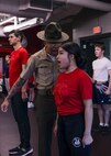 U.S. Marine Corps Sgt. Harry Le, a drill instructor with Bravo Company, 1st Recruit Training Battalion, corrects a poolee during Recruiting Sub-Station Madison’s Drill Instructor Night at Milton High School, Milton WI, March 19, 2024. The purpose of Drill Instructor Night is to introduce poolees to incentive training, basic drill movements and give family and friends the opportunity to ask questions about recruit training and the Marine Corps. (U.S. Marine Corps photo by Cpl. Collette Hagen)