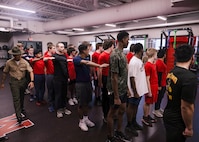Poolees from Recruiting Sub-Station Madison receive instruction on close order drill during Drill Instructor Night at Milton High School, Milton WI, March 19, 2024. The purpose of Drill Instructor Night is to introduce poolees to incentive training, basic drill movements and give family and friends the opportunity to ask questions about recruit training and the Marine Corps. (U.S. Marine Corps photo by Cpl. Collette Hagen)