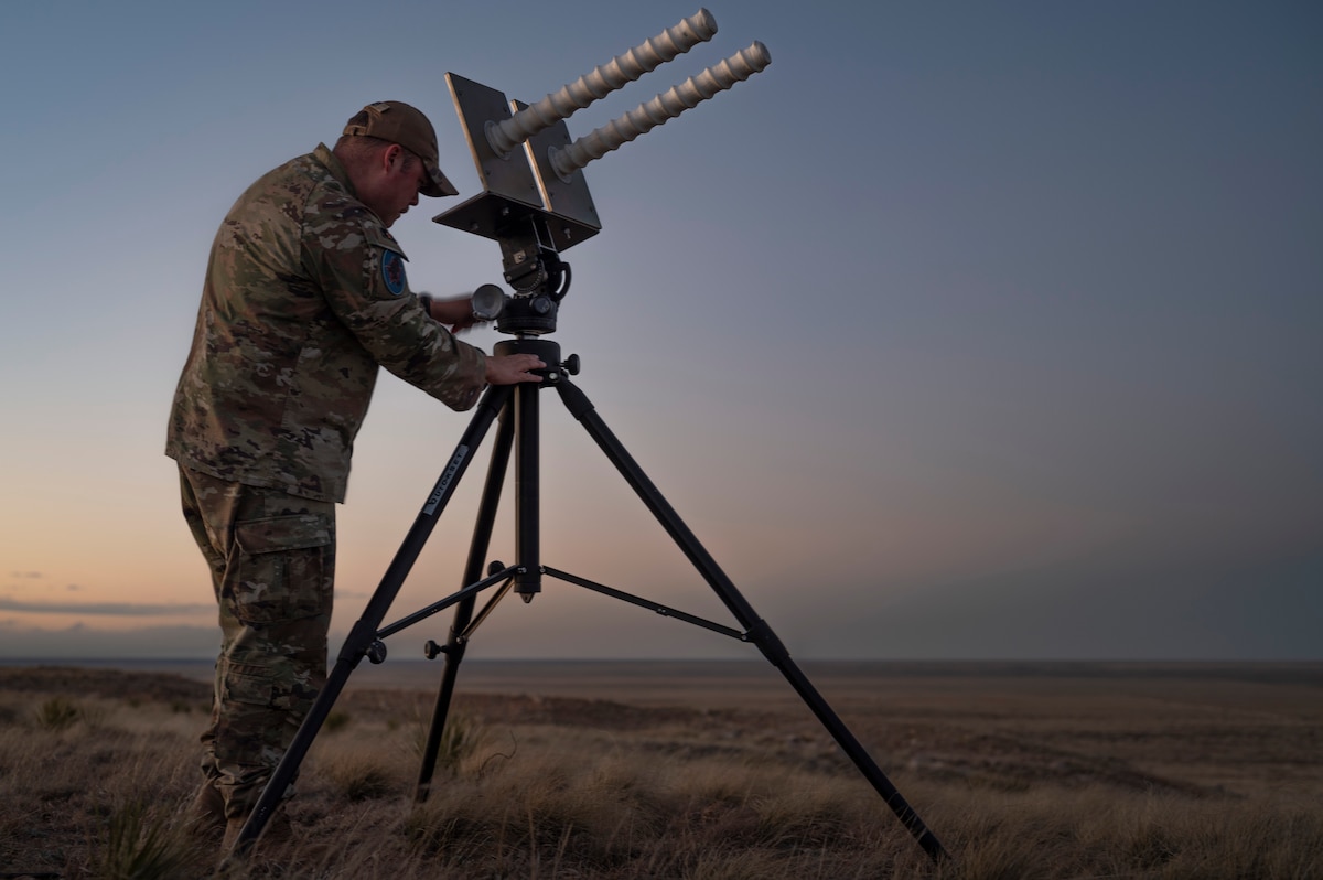 U.S. Space Force Tech Sgt. Kyle Yeager, flight chief of the 527th Space Aggressor Maintenance Flight and certified GPS operator, adjusts the tilt of the helical antenna in preparation for training exercise with the AC-130J Ghostrider at Cannon Air Force Base, New Mexico on March 5, 2024.