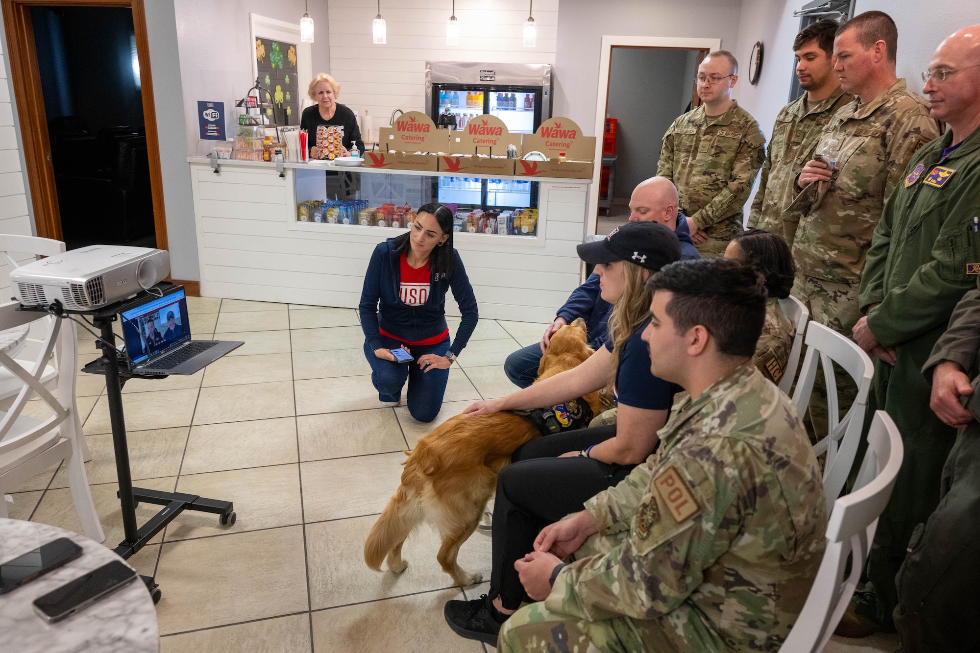 Ranger, Delaware USO therapy dog, along with USO staff and members of Team Dover, speak with Cesar Millan, dog trainer and star of the Emmy-nominated television series The Dog Whisperer, via webcam at Dover Air Force Base, Delaware, March 15, 2024. Milan spoke with staff and service members from the USO centers of the four finalists of the 2023 USO Canine Volunteer of the Year Award to congratulate them and answer questions. (U.S. Air Force photo by Mauricio Campino)