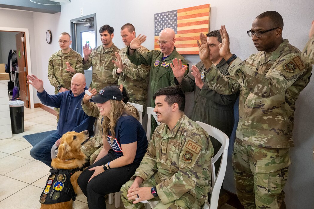 Ranger, Delaware USO therapy dog, along with USO staff and members of Team Dover, speak with Cesar Millan, dog trainer and star of the Emmy-nominated television series “The Dog Whisperer,” via webcam at Dover Air Force Base, Delaware, March 15, 2024. Milan spoke with staff and service members from the USO centers of the four finalists of the 2023 USO Canine Volunteer of the Year Award to congratulate them and answer questions. (U.S. Air Force photo by Mauricio Campino)