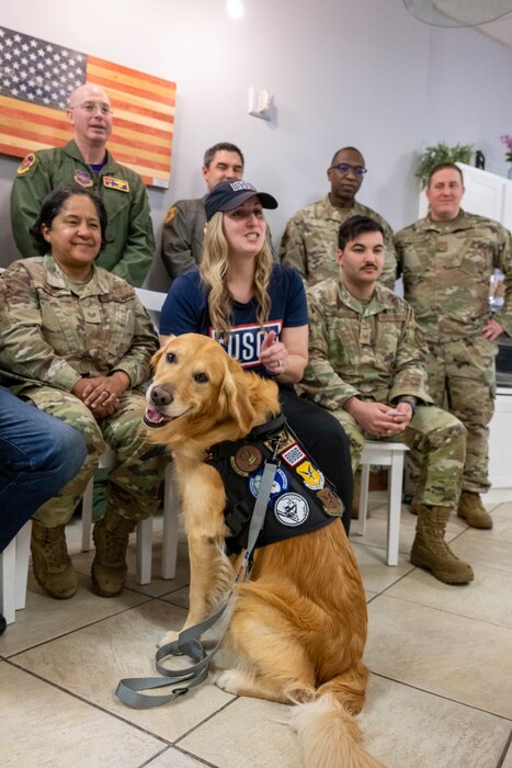Ranger, Delaware USO therapy dog, along with USO staff and members of Team Dover, speak with Cesar Millan, dog trainer and star of the Emmy-nominated television series “The Dog Whisperer,” via webcam at Dover Air Force Base, Delaware, March 15, 2024. Milan spoke with staff and service members from the USO centers of the four finalists of the 2023 USO Canine Volunteer of the Year Award to congratulate them and answer questions. (U.S. Air Force photo by Mauricio Campino)