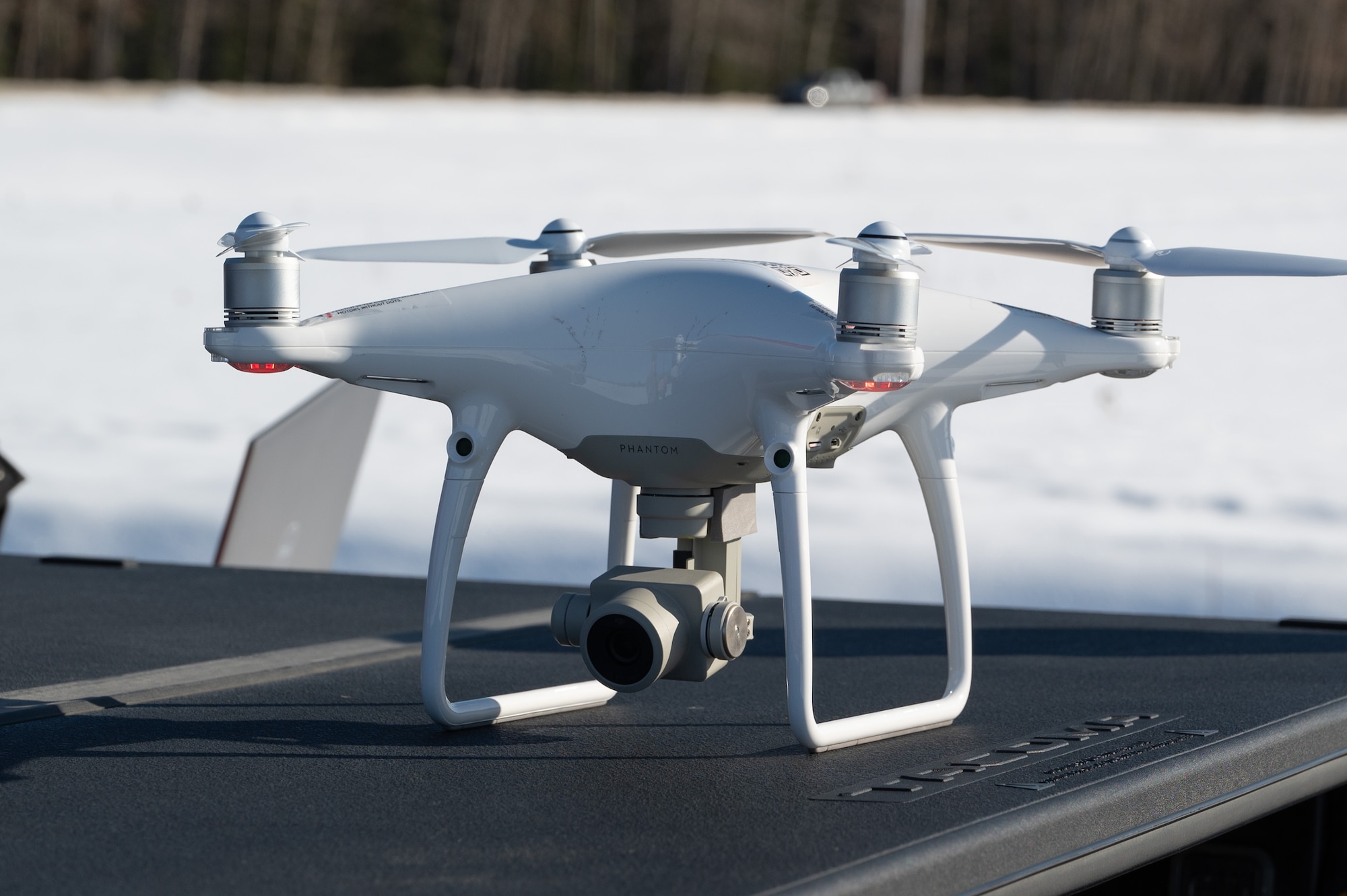 A drone sits on top of a trunk bed cover in preparation for take-off for the drone test.