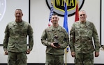 Staff Sgt. Alexander Kilbane (center), a unit movement officer planning instructor assigned to Headquarters and Headquarters Detachment, 2nd Battalion, 426th Regional Training Institute, poses with Brig. Gen. Daniel Pulvermacher (left), the assistant adjutant general for readiness and training for Army, and Command Sgt. Maj. Curtis Patrouille, the state senior enlisted leader (right), after receiving the award for Wisconsin Army National Guard Best Warrior Competition 2024 Noncomissioned Officer of the Year. (U.S. National Guard photo by Sgt. Payton Wehr)