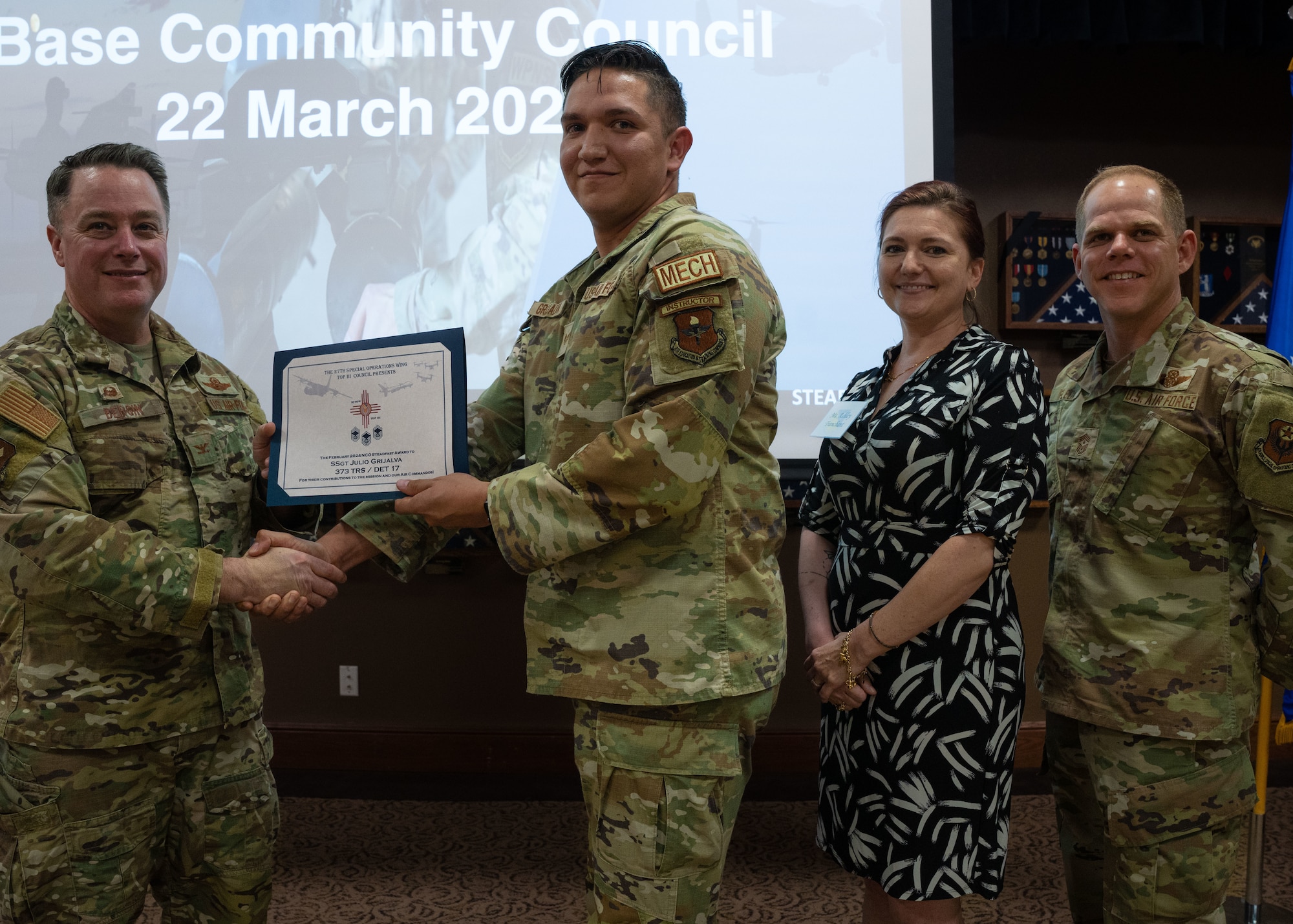 U.S Air Force Staff Sgt. Julio Grijalva, assigned
to the 373rd Training Squadron, Det 17, receives
the Top III Steadfast Line award from U.S. Air
Force Col. Jeremy Bergin, 27th Special
Operations Wing commander at Cannon Air Force
Base, N.M., March 22, 2024, during the Base
Community Council. The BCC is an
action-oriented, multi-community organization
that supports the common interest of the military
and civilian communities through mutual
understanding and joint participation in common
activities. (U.S Air Force Photo by Senior
Airman Mateo Parra)