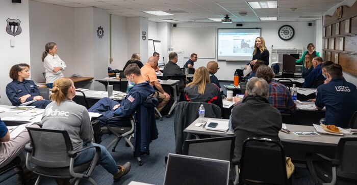 A photo of a classroom full of people.