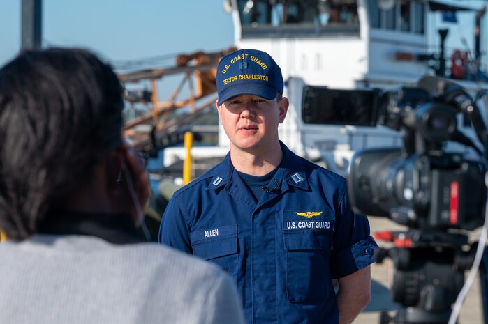 A photo of a man in front of a camera.