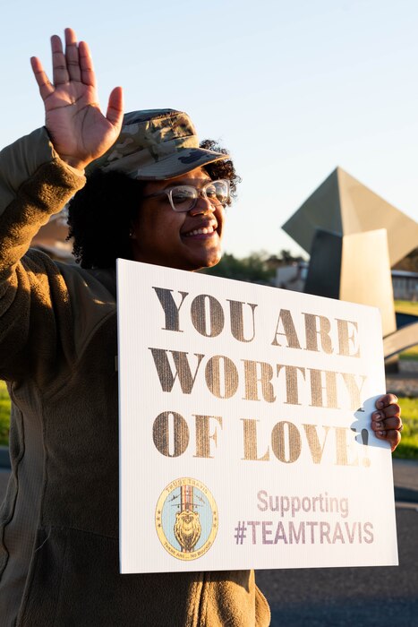 Volunteer holds a sign.