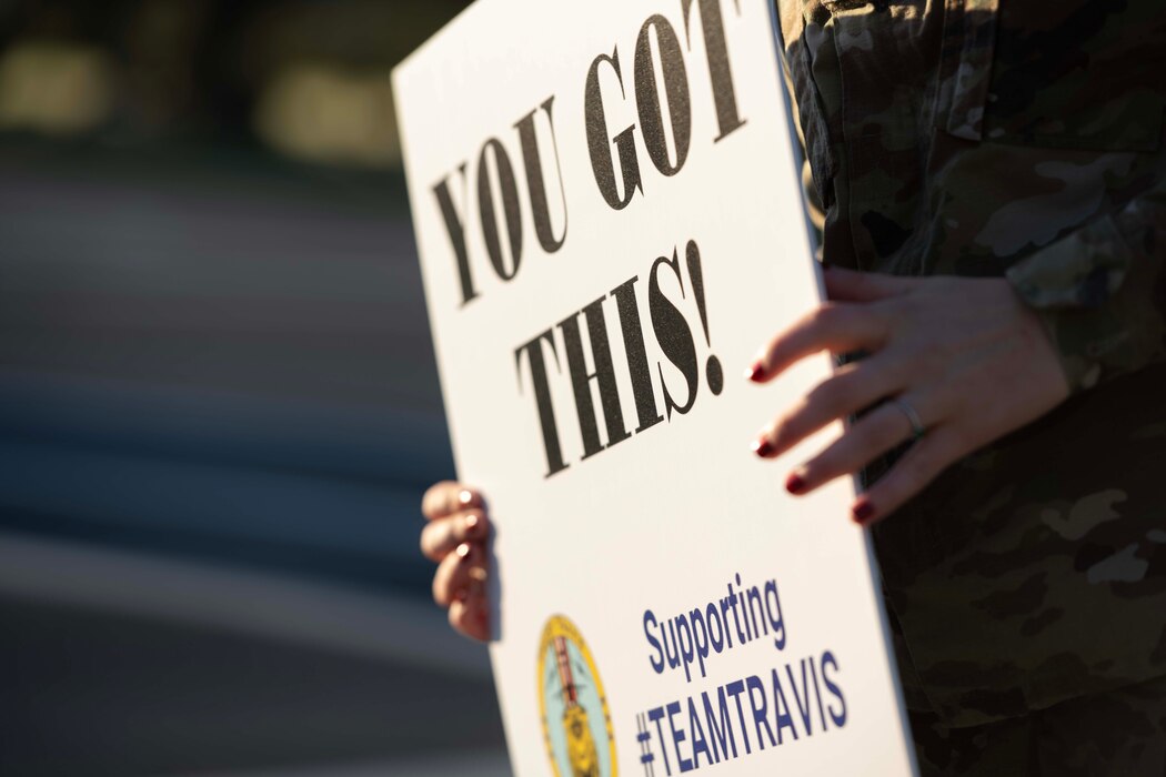 Volunteer holds a sign.