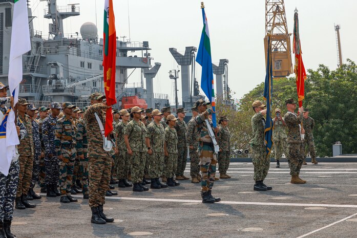 Republic of India service members, U.S. Marines assigned to the 15th Marine Expeditionary Unit, and Sailors assigned to the amphibious transport dock USS Somerset (LPD 25), stand together in formation during the opening ceremony of Exercise Tiger TRIUMPH in Visakhapatnam, India, March 19, 2024. Tiger TRIUMPH is a U.S.-India tri-service amphibious exercise focused on humanitarian assistance and disaster relief readiness and interoperability. Tiger TRIUMPH enables U.S. and Indian Armed Forces to improve interoperability and bilateral, joint, and service readiness in the Indian Ocean region and beyond to better achieve mutual regional security objectives. (U.S. Marine Corps photo by Cpl. Aidan Hekker)