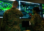 Marines with Marine Corps Forces Cyberspace Command pose for photos in the cyber operations center at Lasswell Hall aboard Fort Meade, Maryland, Feb. 5, 2020. MARFORCYBER Marines conduct offensive and defensive cyber operations in support of United States Cyber Command and operate, secure and defend the Marine Corps Enterprise Network. This image is a photo illustration.