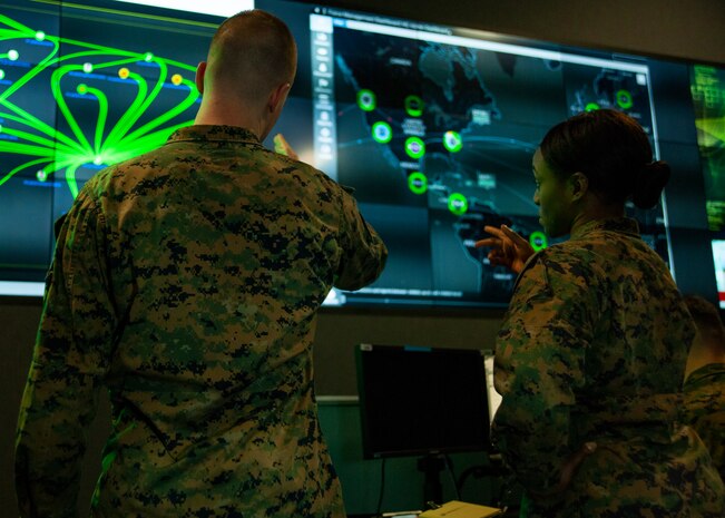 Marines with Marine Corps Forces Cyberspace Command pose for photos in the cyber operations center at Lasswell Hall aboard Fort Meade, Maryland, Feb. 5, 2020. MARFORCYBER Marines conduct offensive and defensive cyber operations in support of United States Cyber Command and operate, secure and defend the Marine Corps Enterprise Network. This image is a photo illustration.