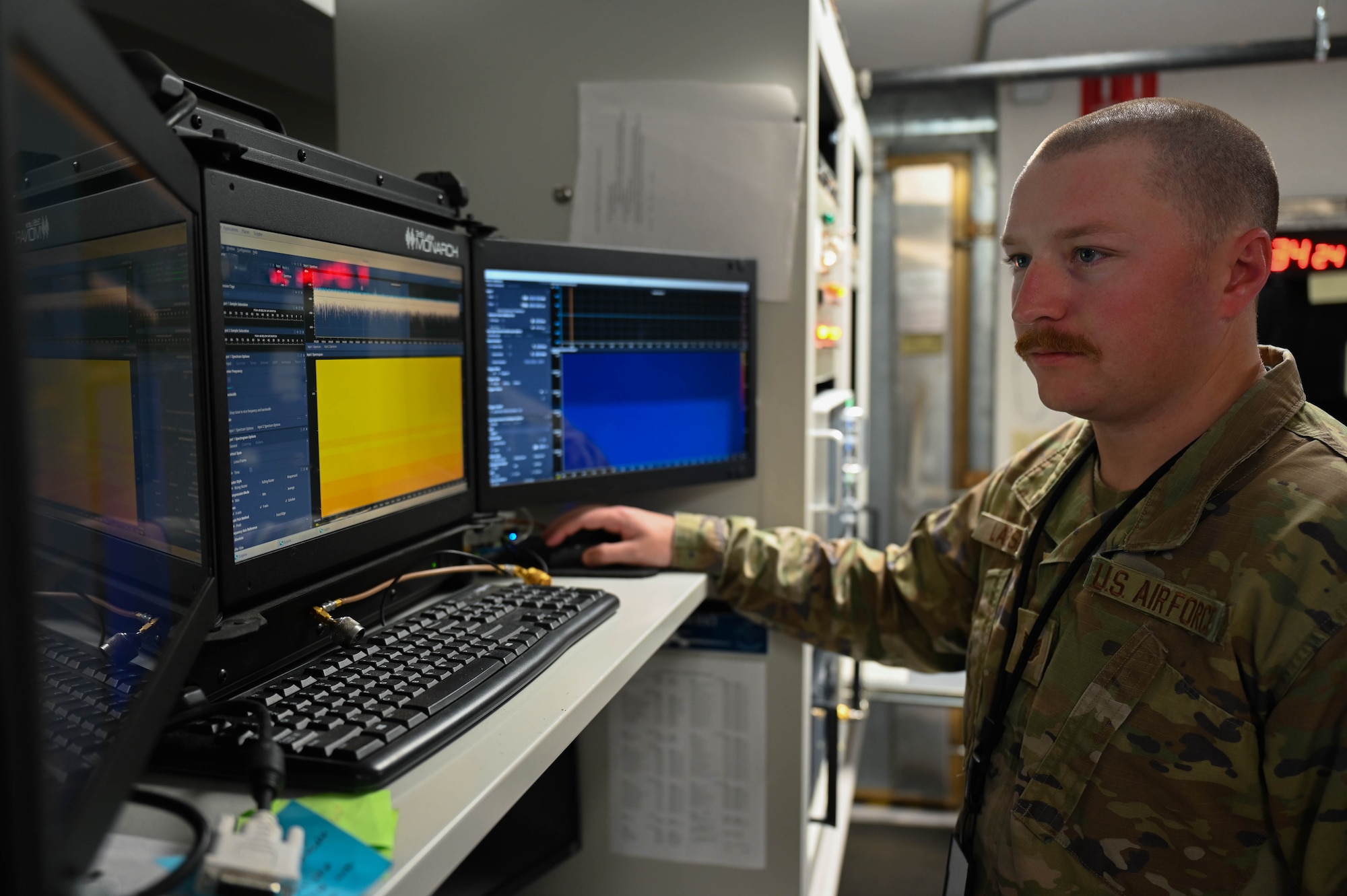 U.S. Air Force Koby Larsen, 16th Electronic Warfare Squadron B-1 Electronic Warfare specialist, analyzes radio frequency signals at the B-1 Lab at Eglin Air Force Base, Fla., Jan. 11, 2024. The 16th EWS provides EW support to U.S. Air Force Global Strike Command assets. (U.S. Air Force photo by Capt. Benjamin Aronson) (This photo has been altered for security purposes by blurring out portions of monitors)