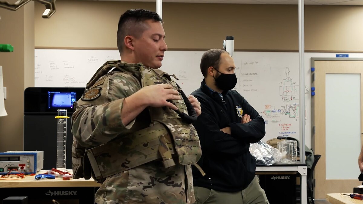 Capt. Justin O'Brien, Experimental Demonstration Branch section chief, Air Force Research Laboratory at Edwards Air Force Base, California, demonstrates the Acclimate Cooling System.