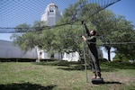 U.S. Air Force Major Parker Hunsuck, 12th Flying Training Wing safety officer, builds an avian capture net system March 25, 2024, at Joint Base San Antonio-Randoph, Texas. The bird capture technique being implemented involves the strategic placement of a net in locations that are known to be frequented by avian species deemed significant threats to aircraft safety. This method, tailored to mitigate the risks associated with bird strikes, employs a system that deploys the net over these critical areas, ensnaring birds that pose potential dangers to flights. (U.S. Air Force photo by Sean Worrell)