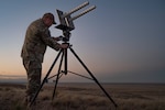 U.S. Space Force Tech Sgt. Kyle Yeager, flight chief of the 527th Space Aggressor Maintenance Flight and certified GPS operator, adjusts the tilt of the helical antenna in preparation for training exercise with the AC-130J Ghostrider at Cannon Air Force Base, New Mexico on March 5, 2024.