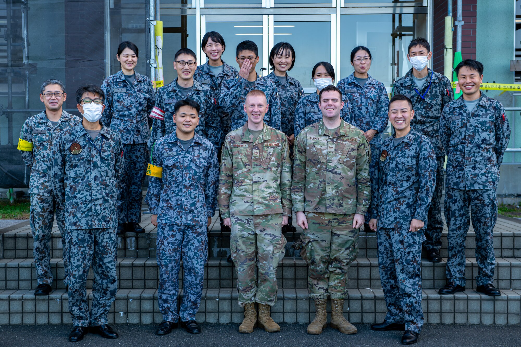 U.S. Air Force Tech. Sgt. Darin Newberry, center-left, 75th Operations Support Squadron mission integration non-commissioned officer in charge, and U.S. Air Force Staff Sgt. Levy, center-right, 75th OSS weather forecaster, pose for a group photo with the Tsuiki Weather Squadron during an Aviation Training Relocation exercise at Tsuiki Air Base, Japan, Dec. 7, 2023. During ATR, Newberry met and discussed weather operations with the Tsuiki weather Airmen, learning on how they conduct their operations, creating weather forecasts and operating as a liaison between the U.S.-Japan forces during the training event.