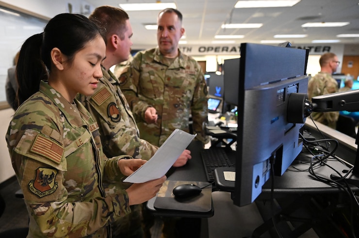 U.S. Airmen look at a computer screen