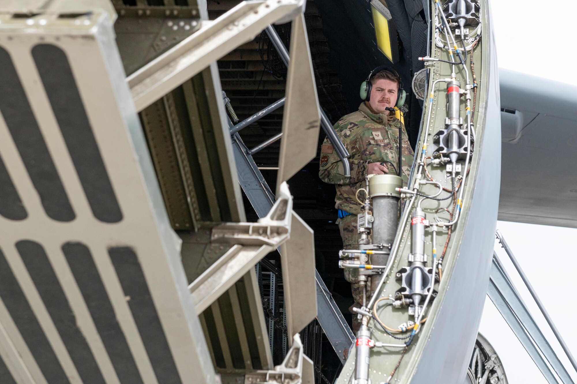 An Airman raises the visor of a C-5M Super Galaxy.