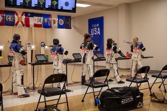 Women in USAMU uniform standing at Indoor Firing range.